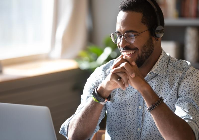 man smiling at laptop